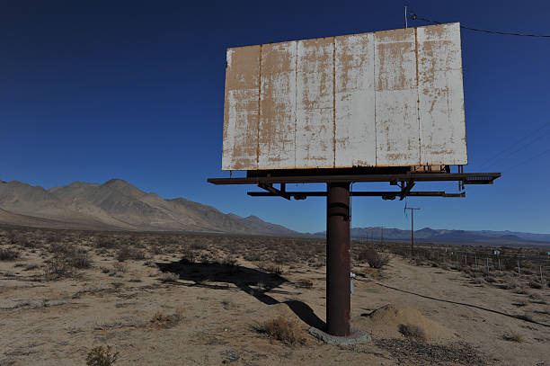 Old rusted blank billboard by road stock photo