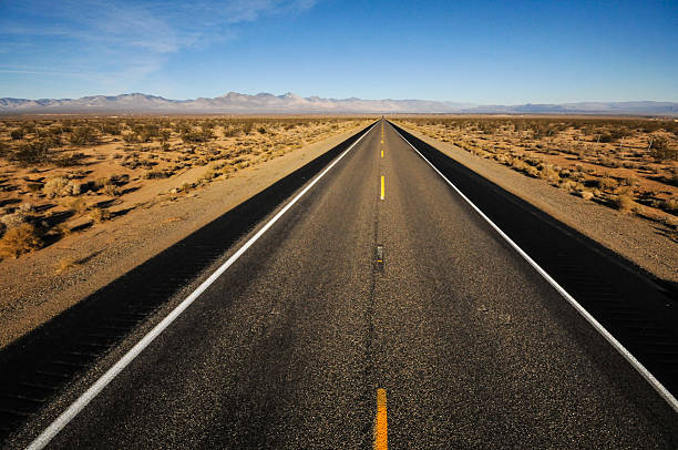 istock Road leads into mountains far away 464218849