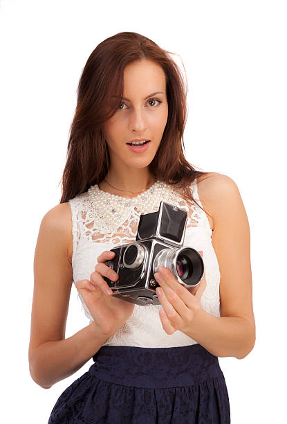 istock Girl with an old camera on a white background 464219193