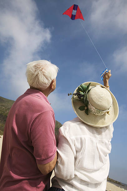istock Couple Flying Kite Together 464220751