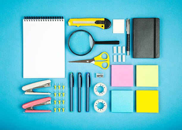 office supply concept various office supplies in order on the blue background stapled paper stock pictures, royalty-free photos & images