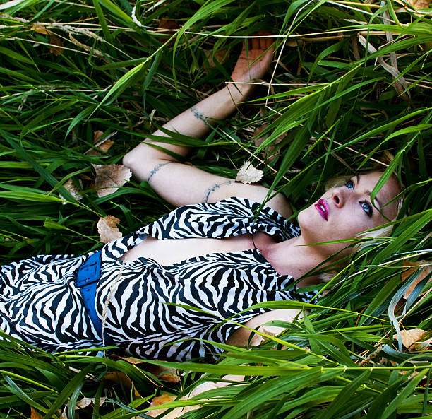 woman lying in grass stock photo