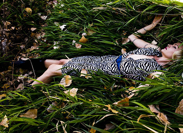woman lying in grass stock photo