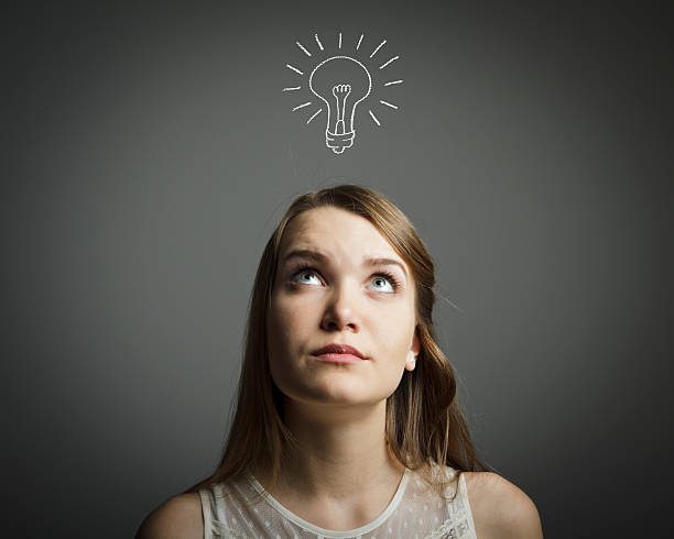 istock Girl in white and light bulb 464237333