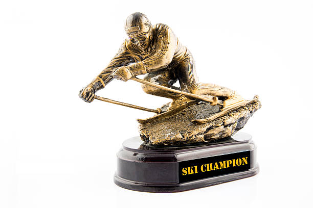 Gold ski champion statuette award isolated on white background