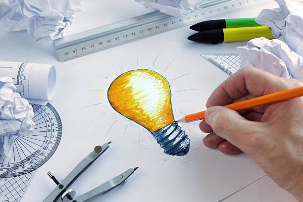Having a bright idea Designer drawing a light bulb, concept for brainstorming and inspiration graphic designer photos stock pictures, royalty-free photos & images