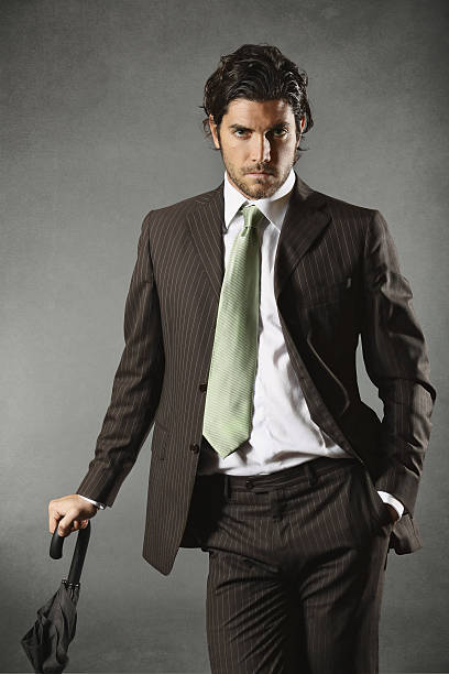 istock Handsome fashion model posing with umbrella 464268063