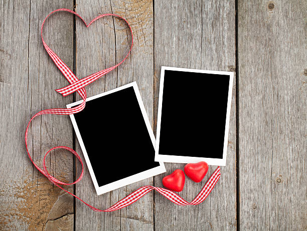 istock Two photo frames and small red candy heart 464271623