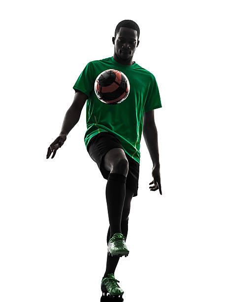istock african man soccer player juggling silhouette 464272705