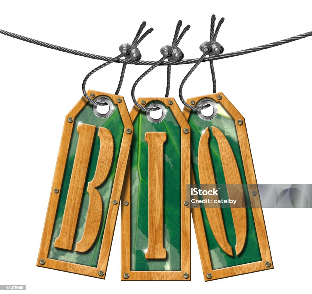 Bio Tags Hanging on White Background Wooden and green tags hanging on a steel cable with written bio . Biology Stock Photo