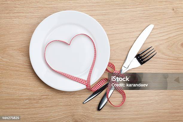 Valentines Day Heart Shaped Red Ribbon Over Plate With Silverware Stock Photo - Download Image Now