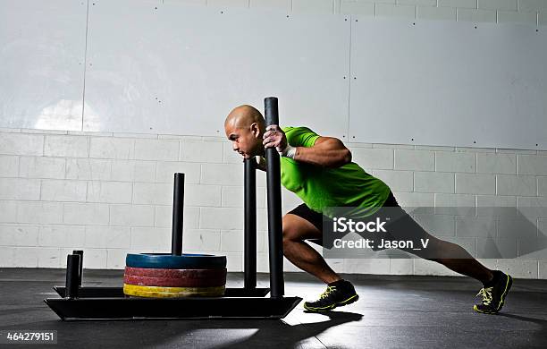 Athletic Man Pushing A Gym Sled Stock Photo - Download Image Now - Sled, Exercising, Pushing