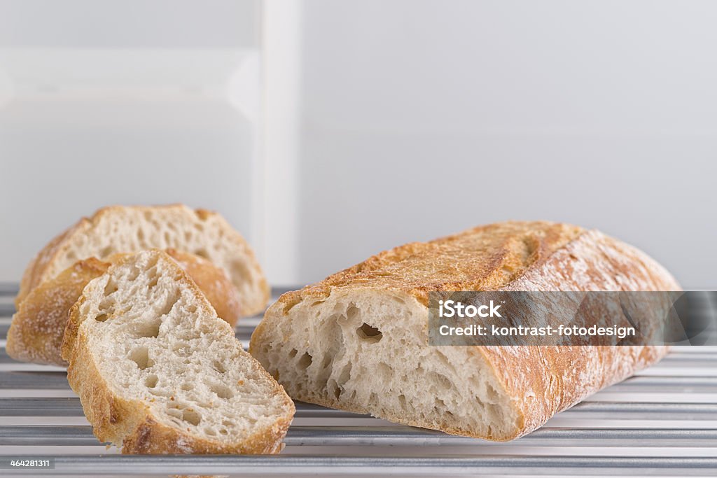 Ciabatta, Italian Bread Close up at an italian ciabatta bread on metal board in front light kitchen background. Alloy Stock Photo