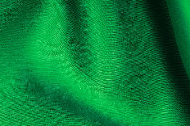 istock green background abstract cloth wavy folds of textile texture 464308703