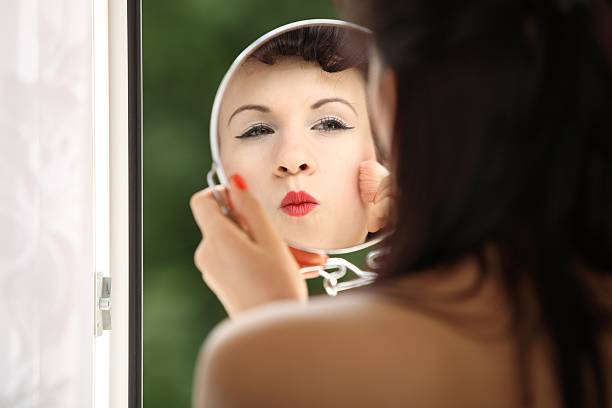 istock girl retro style applying make up looking at mirror indoor 464308721