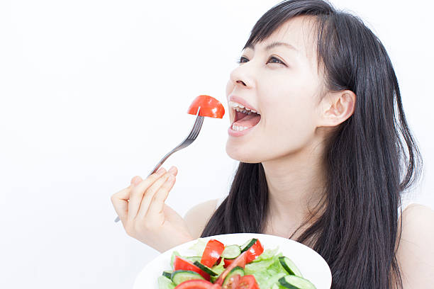istock girl eating salad 464311913
