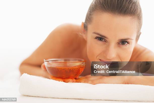 Smiling Woman Laying On Massage Table With Plate Of Honey Stock Photo - Download Image Now