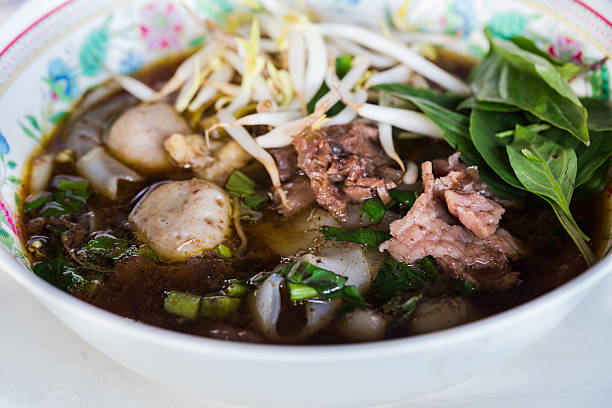 istock Wide rice noodle in thick soup with beef 464317357