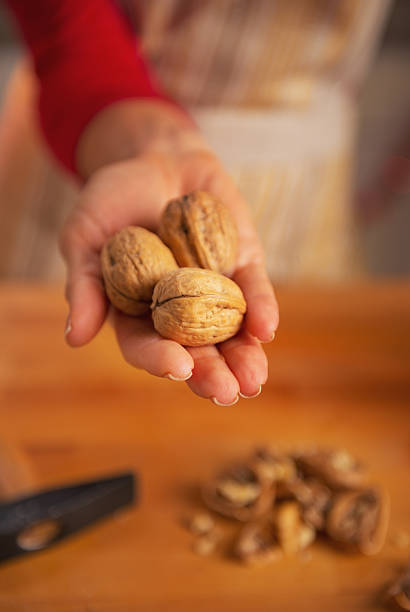 istock closeup on young housewife showing walnuts 464317891