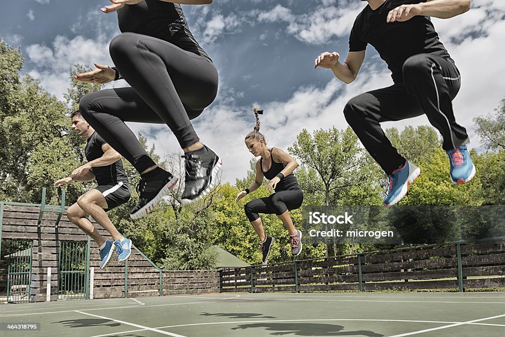 Power jump exercise Fitness team doing a power jump exercise Outdoors Stock Photo