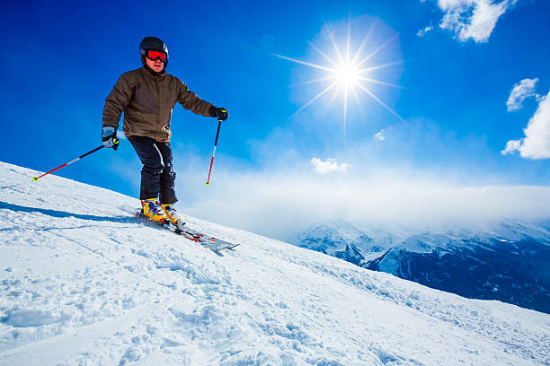 istock Skier on slope of ski resort 464319423