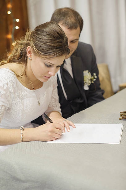 istock Bride and Groom Signing Papers 464319819