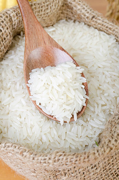 istock wooden spoon with raw rice 464334727