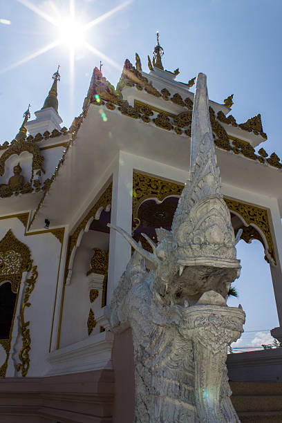 istock Naga statue with White pagoda in thai temple 464340523