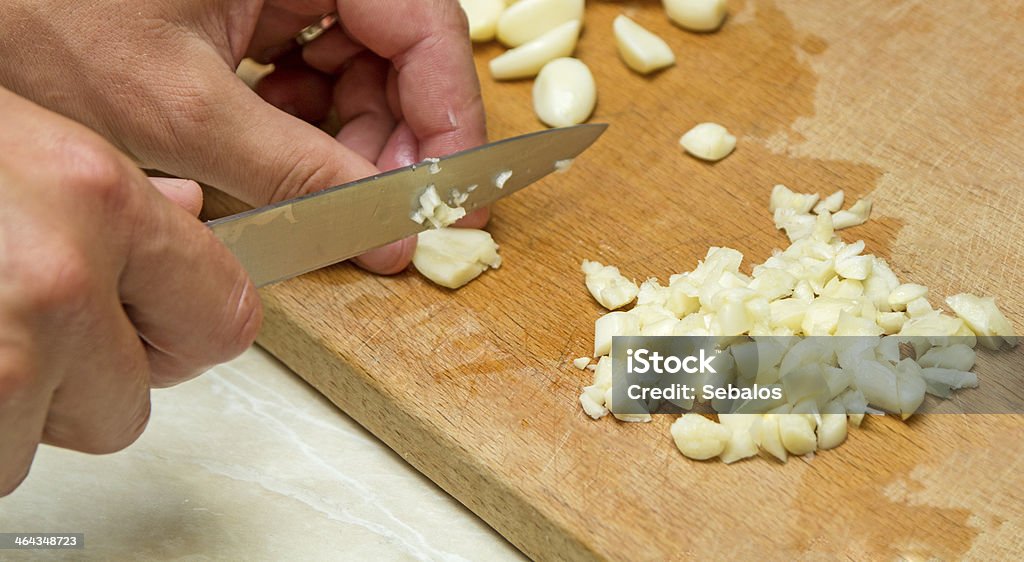 Man chopping the garlic Man chopping the garlic with knife. Chopping Food Stock Photo