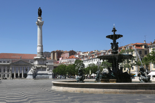 Rossio square in Lisbon Portugal with a statue and a fountain