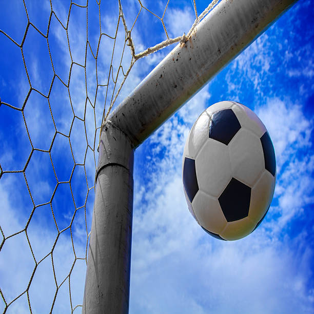 istock Soccer ball in goal 464350599