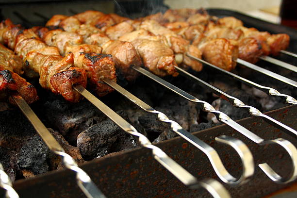 istock Marinated lamb grilling on metal skewer 464353159