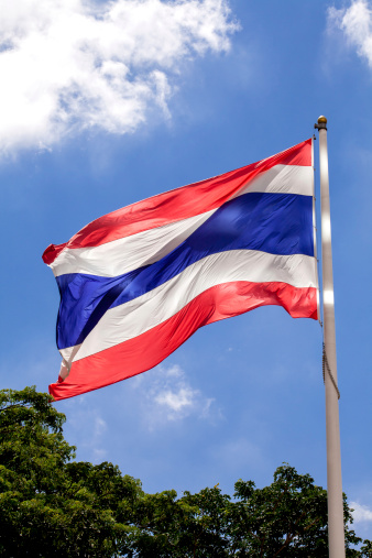 Thailand Flag Waving in the wind with blue sky and cloud