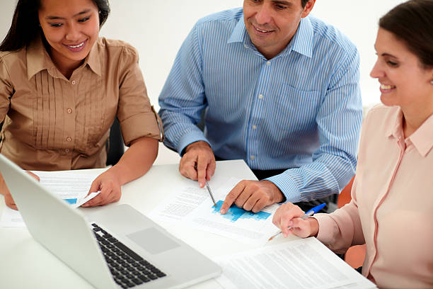 istock Male and female coworkers working on documents 464354701