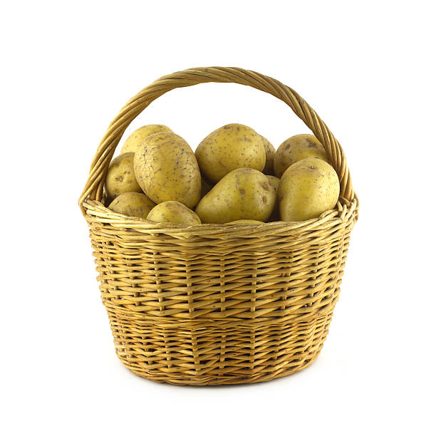 istock Potatoes in brown wicker basket isolated closeup 464356231