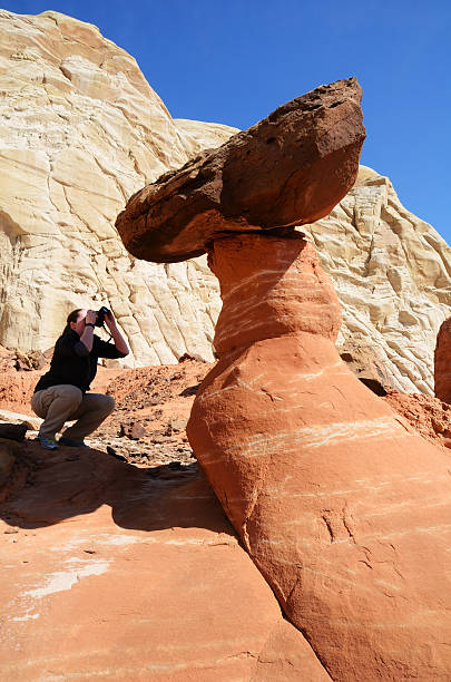 istock Woman Photographing a Paria Rimrocks Red Toadstool 464356281