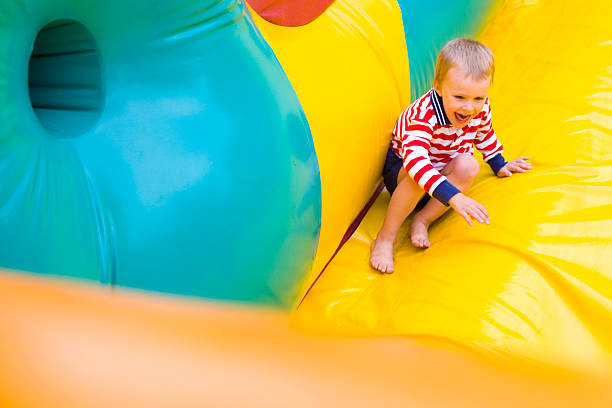 istock Four-year-old kid playing on a trampoline outdoor 464361539