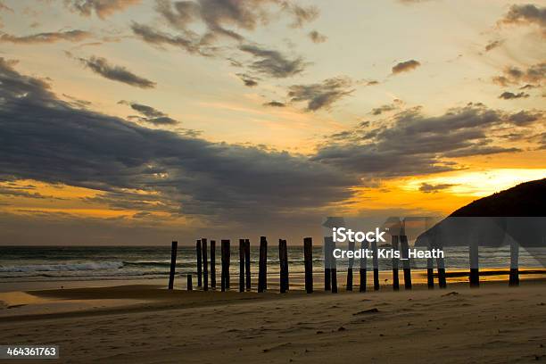 Sunset Over An Old Pier On A Beach Stock Photo - Download Image Now - Beach, Horizontal, No People