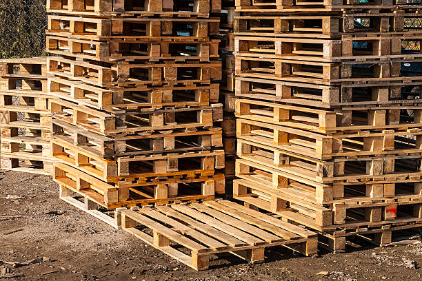 istock Wooden transport pallets in stacks ready for delivery. 464363657