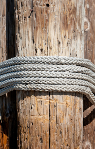 Close up of a rope lashing on a lakeside pier