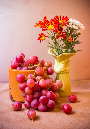 flower and Red grape fruit still life