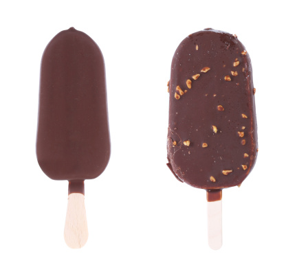 Two chocolate-coated blocks of ice cream on stick. White background.