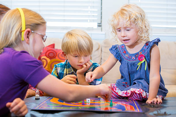 istock Group of kids playing a board game 464381503