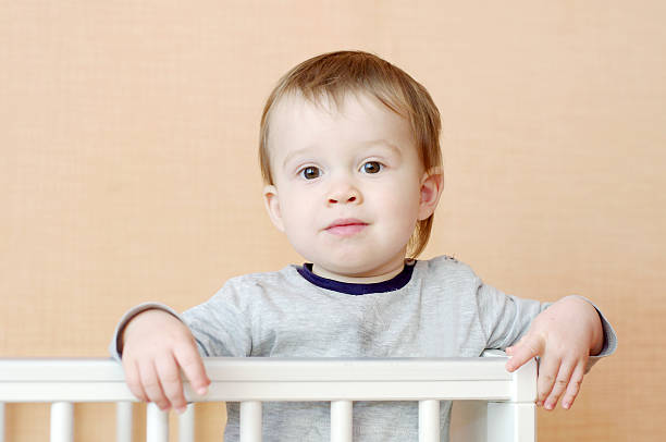 istock lovely baby in white bed 464385225