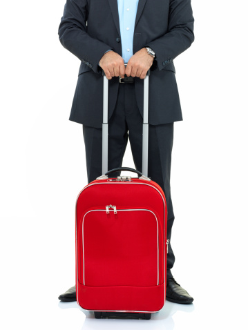 Businessman is waiting with valise on white background,