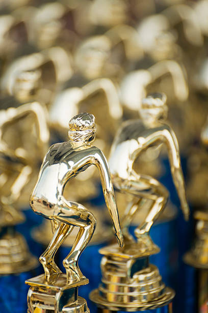 istock Rows of First Place Swimming Trophies 464387837