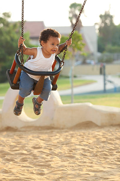 istock Little boy swinging at the playground. 464392115