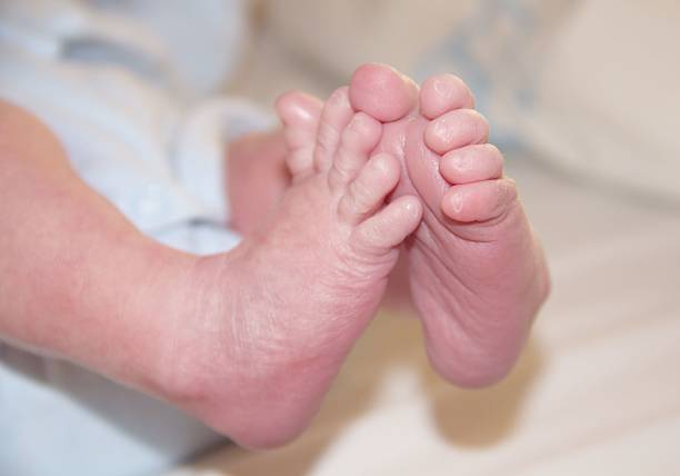 Baby's legs close up on a light blanket. Place for text. The concept of children's health, safety, love