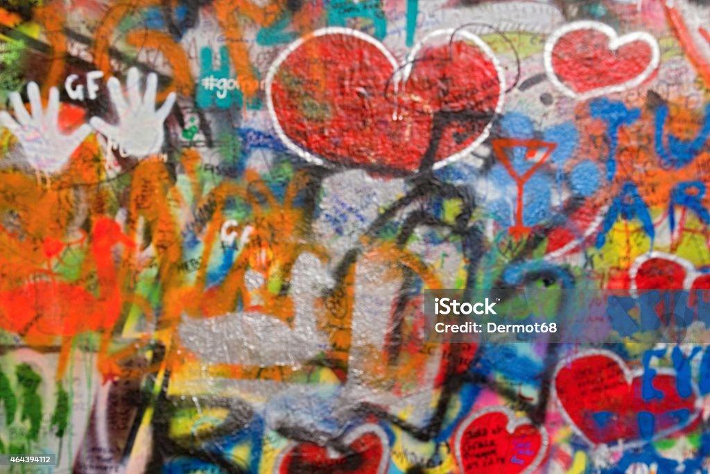 Urban wall with drawings in Prague - blurred background Photo shows a closeup of various drawings and paintings on the urban wall. John Lennon Stock Photo