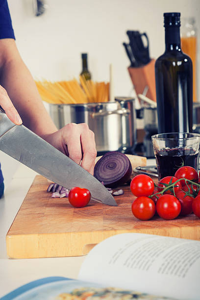 istock retro image of ingredients for pasta and hands chopping tomatos 464394997